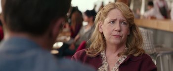 Movie still from “Collateral Beauty” (2016), directed by David Frankel – A person sitting at a table; Close Up shot, Over the shoulder angle