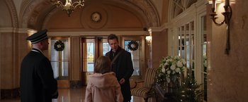 Movie still from “Collateral Beauty” (2016), directed by David Frankel – A man and a woman are standing in front of a door way; Medium shot, Over the shoulder angle