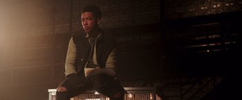 Movie still from “Collateral Beauty” (2016), directed by David Frankel – A man sitting on top of a bench in a dark room; Medium shot, Low angle