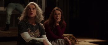 Movie still from “Collateral Beauty” (2016), directed by David Frankel – Two women sitting next to each other in a room; Medium shot, Over the shoulder angle
