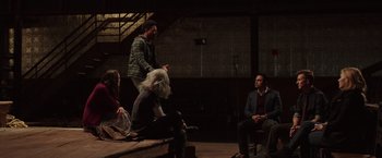 Movie still from “Collateral Beauty” (2016), directed by David Frankel – A group of people sitting on top of a wooden bench; Wide shot, High angle