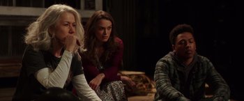 Movie still from “Collateral Beauty” (2016), directed by David Frankel – A group of people sitting around a room together; Medium shot, Over the shoulder angle