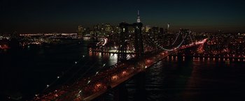 Movie still from “Collateral Beauty” (2016), directed by David Frankel – A view of a city at night from a bridge; Extreme Wide shot, High angle