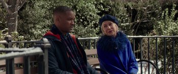 Movie still from “Collateral Beauty” (2016), directed by David Frankel – A man and a woman sitting next to each other on a park bench; Medium shot, Over the shoulder angle