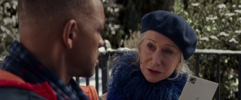 Movie still from “Collateral Beauty” (2016), directed by David Frankel – An older woman wearing a blue beret talking to an older man; Close Up shot, Over the shoulder angle