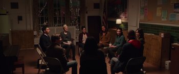 Movie still from “Collateral Beauty” (2016), directed by David Frankel – A group of people sitting in a circle at night; Wide shot, High angle