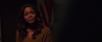 Movie still from “Collateral Beauty” (2016), directed by David Frankel – A woman with long dark curly hair wearing a brown sweater; Close Up shot, Over the shoulder angle