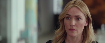 Movie still from “Collateral Beauty” (2016), directed by David Frankel – A person with long blonde hair; Close Up shot, Over the shoulder angle