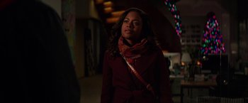 Movie still from “Collateral Beauty” (2016), directed by David Frankel – A woman wearing a red coat and a scarf; Medium shot, Over the shoulder angle