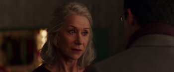 Movie still from “Collateral Beauty” (2016), directed by David Frankel – An older woman with long gray hair looking at the camera; Close Up shot, Over the shoulder angle