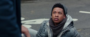 Movie still from “Collateral Beauty” (2016), directed by David Frankel – A man sitting on the side of the road wearing a scarf; Close Up shot, Over the shoulder angle