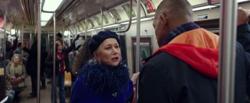 Movie still from “Collateral Beauty” (2016), directed by David Frankel – An older woman wearing a blue coat and a black hat; Close Up shot, Over the shoulder angle