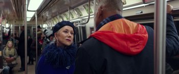 Movie still from “Collateral Beauty” (2016), directed by David Frankel – A woman in a blue dress and a man in a black jacket on a train; Close Up shot, Over the shoulder angle