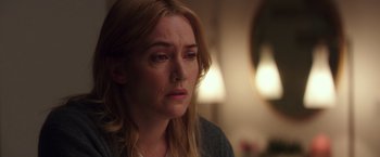 Movie still from “Collateral Beauty” (2016), directed by David Frankel – A person with long blonde hair; Close Up shot, Over the shoulder angle