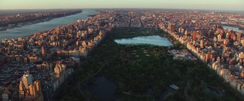 Movie still from “Collateral Beauty” (2016), directed by David Frankel – An aerial view of a large city with a lake in the center; Extreme Wide shot, High angle