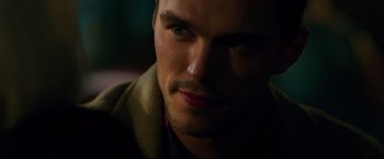 Movie still from “Collide” (2016), directed by Eran Creevy – A man's face in the dark; Close Up shot, Over the shoulder angle