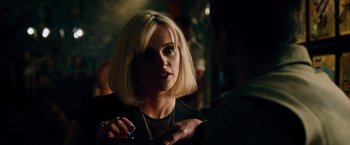 Movie still from “Collide” (2016), directed by Eran Creevy – A woman with blonde hair talking to a man in a bar; Close Up shot, Over the shoulder angle