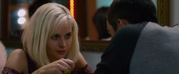 Movie still from “Collide” (2016), directed by Eran Creevy – A woman sitting in front of a man in front of a mirror; Close Up shot, Over the shoulder angle