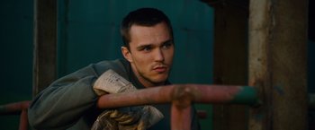 Movie still from “Collide” (2016), directed by Eran Creevy – A person leaning on a railing; Close Up shot, High angle