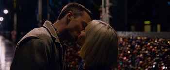Movie still from “Collide” (2016), directed by Eran Creevy – A man and a woman kissing in front of a christmas tree; Close Up shot, Overhead angle