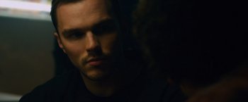 Movie still from “Collide” (2016), directed by Eran Creevy – A man's face in the dark; Close Up shot, Over the shoulder angle