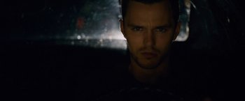 Movie still from “Collide” (2016), directed by Eran Creevy – A person in a dark room; Close Up shot, Over the shoulder angle
