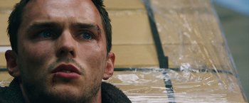Movie still from “Collide” (2016), directed by Eran Creevy – A person's face with a bandage on; Close Up shot, Low angle