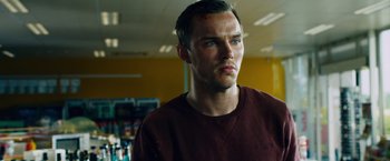 Movie still from “Collide” (2016), directed by Eran Creevy – A person wearing a red shirt; Close Up shot, Low angle