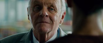 Movie still from “Collide” (2016), directed by Eran Creevy – An older man with a blue eye stares into the distance; Close Up shot, Low angle