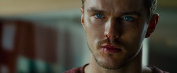 Movie still from “Collide” (2016), directed by Eran Creevy – A person with a bruise on his face; Close Up shot, Low angle