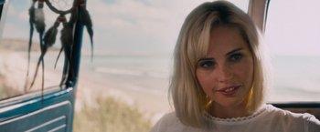 Movie still from “Collide” (2016), directed by Eran Creevy – A person wearing a white shirt near the ocean; Close Up shot, Over the shoulder angle