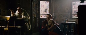 Movie still from “Collide” (2016), directed by Eran Creevy – A man and a woman sitting in a room; Wide shot, High angle