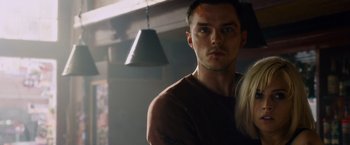 Movie still from “Collide” (2016), directed by Eran Creevy – A man and a woman standing next to each other in a room; Close Up shot, Low angle