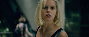 Movie still from “Collide” (2016), directed by Eran Creevy – A person with blonde hair; Close Up shot, Over the shoulder angle
