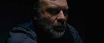 Movie still from “Collide” (2016), directed by Eran Creevy – A person with a beard; Close Up shot, Low angle