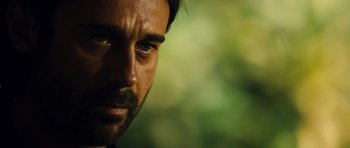 Movie still from “Colombiana” (2011), directed by Olivier Megaton – A man with a beard and mustache; Close Up shot, Over the shoulder angle