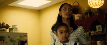 Movie still from “Colombiana” (2011), directed by Olivier Megaton – A woman and a young girl standing next to each other in a room; Close Up shot, Low angle