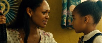 Movie still from “Colombiana” (2011), directed by Olivier Megaton – A person sitting in front of a mirror; Close Up shot, Over the shoulder angle