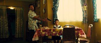 Movie still from “Colombiana” (2011), directed by Olivier Megaton – A young boy sitting at a dining room table; Medium shot, Over the shoulder angle