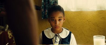 Movie still from “Colombiana” (2011), directed by Olivier Megaton – A young girl looking into a mirror in front of a yellow wall; Close Up shot, High angle
