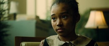 Movie still from “Colombiana” (2011), directed by Olivier Megaton – A young girl is sitting in a chair; Close Up shot, Over the shoulder angle