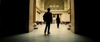 Movie still from “Colombiana” (2011), directed by Olivier Megaton – Two people are walking in a large hallway; Extreme Wide shot, Low angle