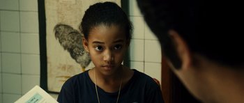 Movie still from “Colombiana” (2011), directed by Olivier Megaton – A young girl looking at the camera in front of a mirror; Close Up shot, Over the shoulder angle