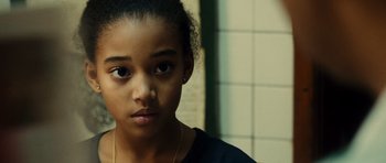 Movie still from “Colombiana” (2011), directed by Olivier Megaton – A young girl is looking into the camera; Close Up shot, Over the shoulder angle