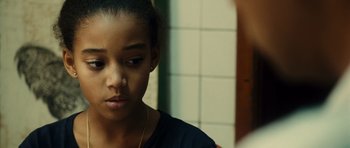 Movie still from “Colombiana” (2011), directed by Olivier Megaton – A young woman looking at her reflection in a mirror; Close Up shot, Over the shoulder angle