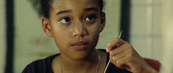 Movie still from “Colombiana” (2011), directed by Olivier Megaton – A young girl is holding a pair of scissors; Close Up shot, Over the shoulder angle