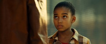 Movie still from “Colombiana” (2011), directed by Olivier Megaton – A young boy looking up into the sky; Close Up shot, Over the shoulder angle