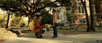 Movie still from “Colombiana” (2011), directed by Olivier Megaton – A man kneeling down next to a young girl; Wide shot, Over the shoulder angle