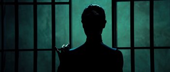 Movie still from “Colombiana” (2011), directed by Olivier Megaton – A man standing in front of a window in the dark; Close Up shot, Low angle