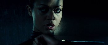 Movie still from “Colombiana” (2011), directed by Olivier Megaton – A person looking at the camera; Close Up shot, Low angle